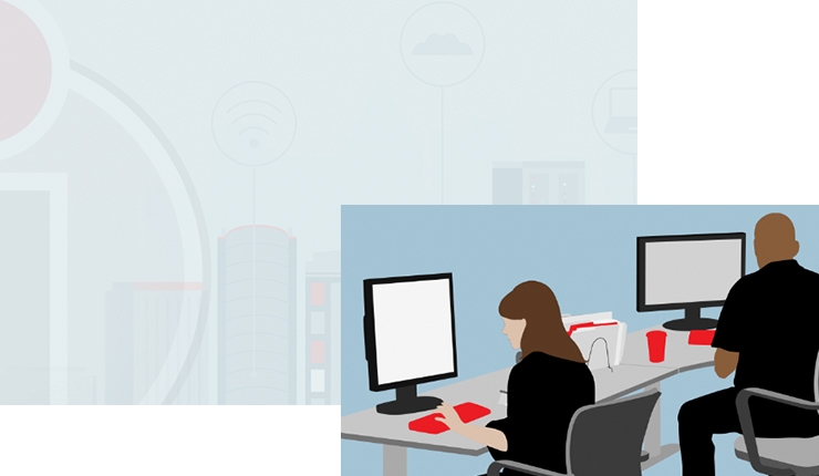 two people at desks viewing screens