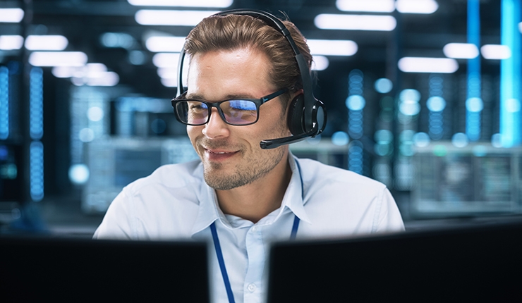 man looking at computer monitors